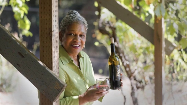 Theodora R. Lee shows off her wine