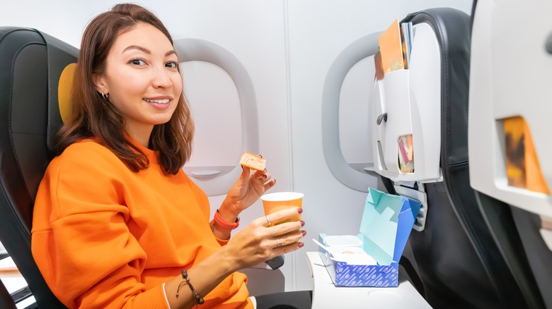 Woman snacking on a plane