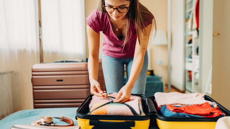 woman packing her belongings