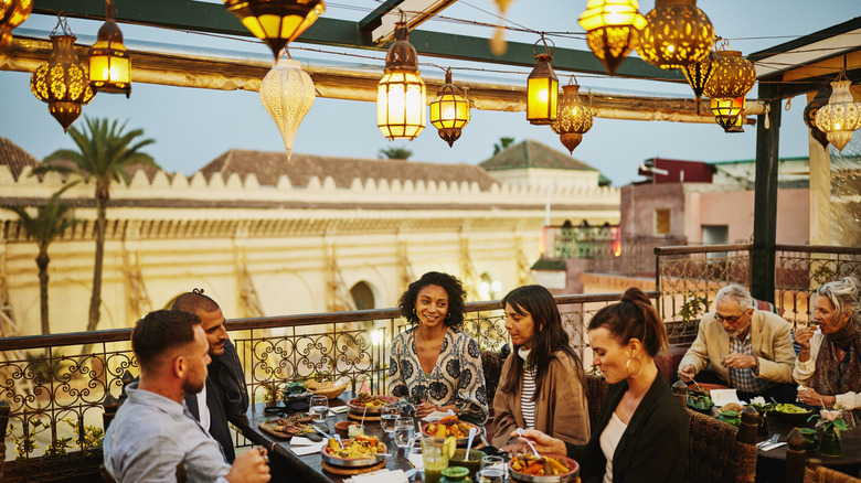 group enjoying a meal on terrace