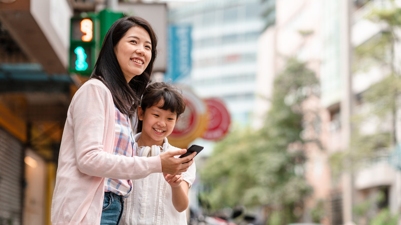 woman and child holding phone