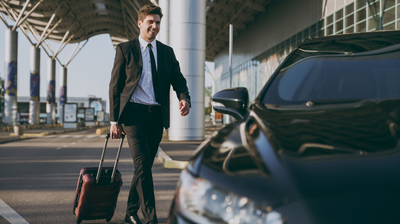 Man in suit by cab