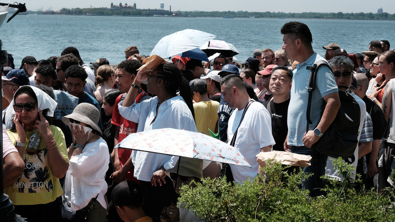 People waiting in heat to visit Statue of Liberty