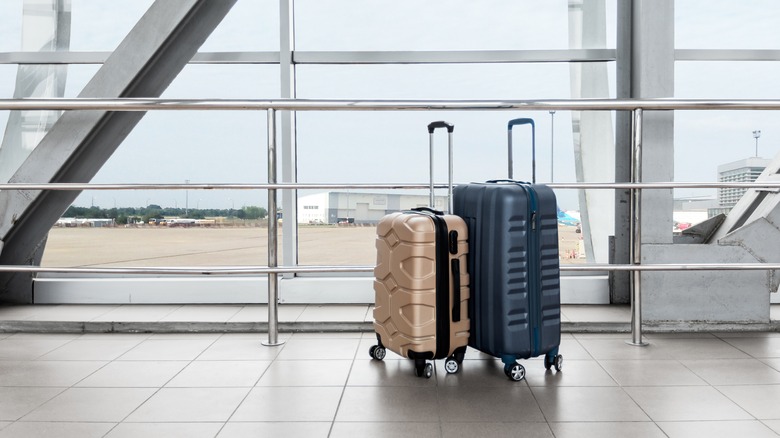 Two suitcases alone in airport