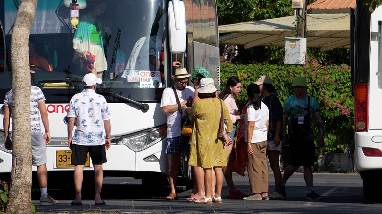 tourists around a tour bus