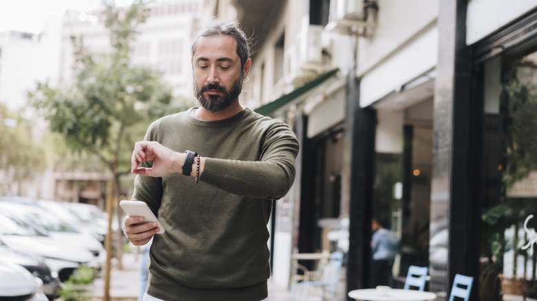 man checking watch