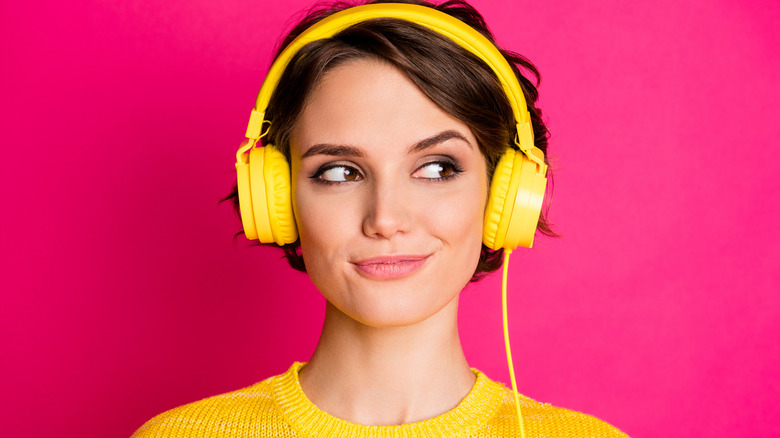 Girl wearing yellow headphones