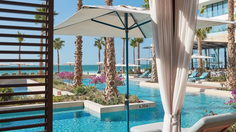 Swimming pools with white umbrellas The Spa at Mandarin Oriental Jumeira