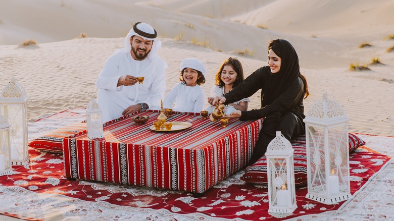 Family enjoying tea in desert