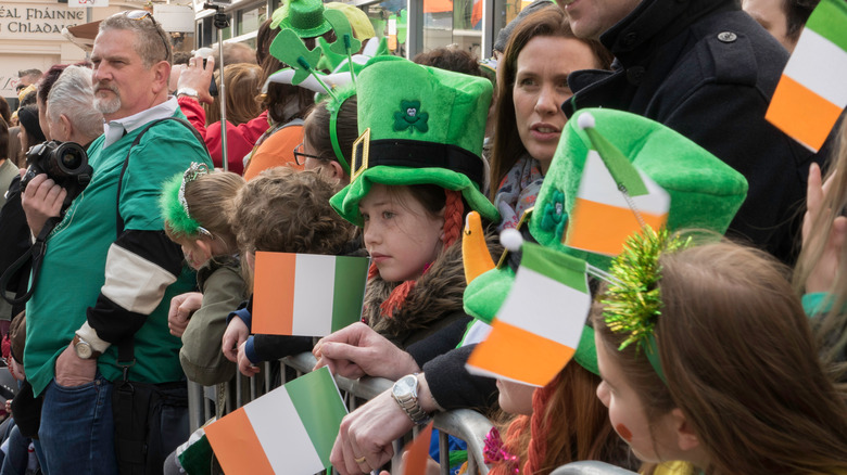 parade watchers with Irish flags