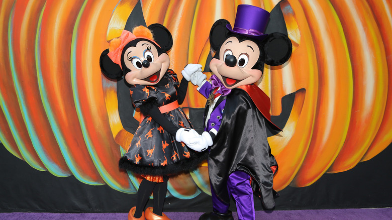 Minnie and Mickey Mouse in Halloween themed clothes