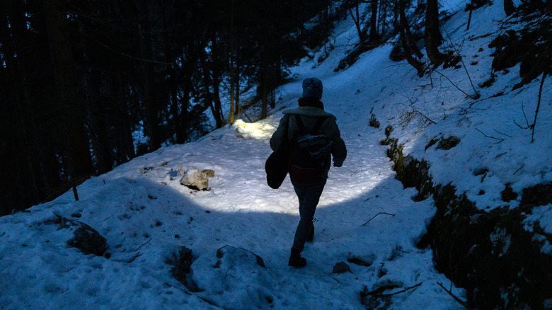 Hiker with headlamp in dark