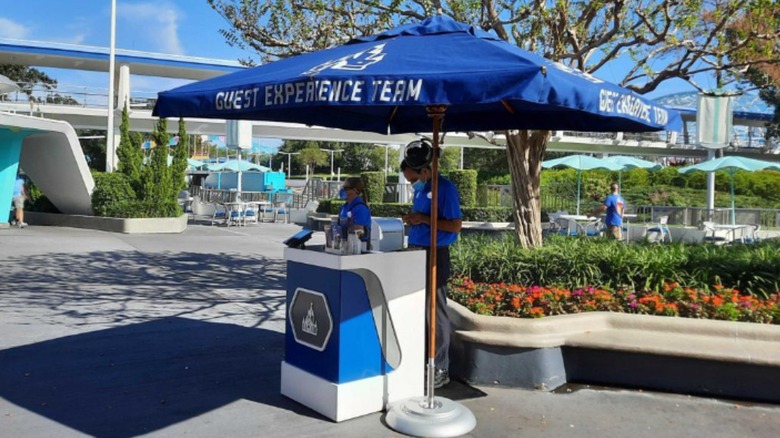 Blue umbrella guest kiosk at Disney