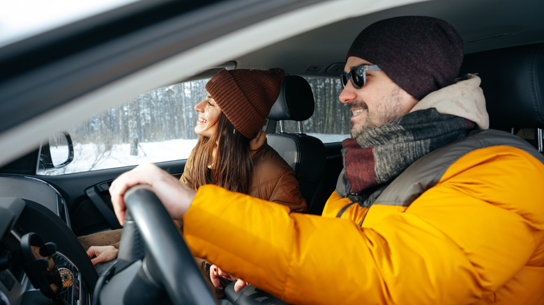 couple driving in winter gear