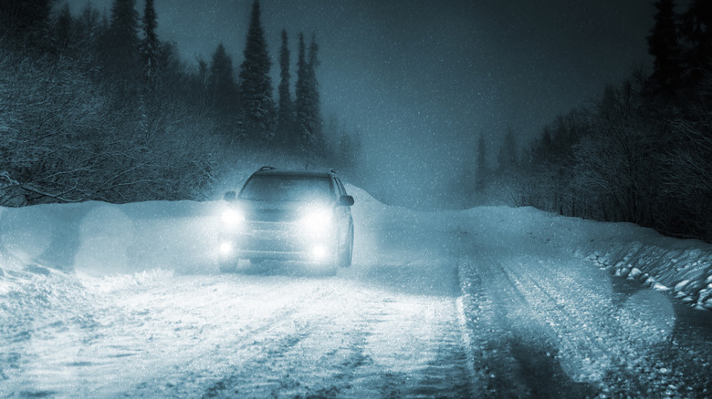 car in snow at night