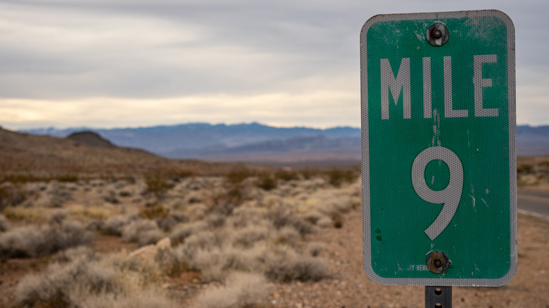 Mile marker sign in desert
