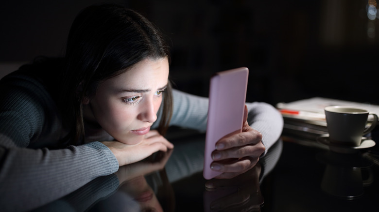 Girl on phone looking stressed