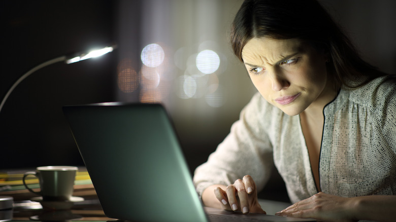 Girl looking at computer suspiciously