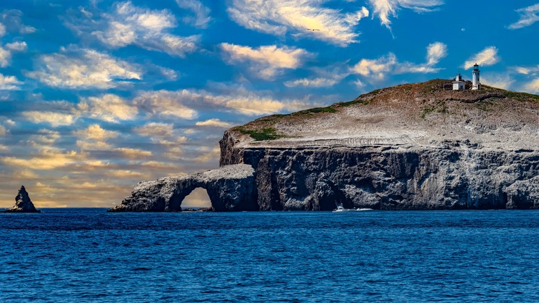 Blue water clouds and bluff