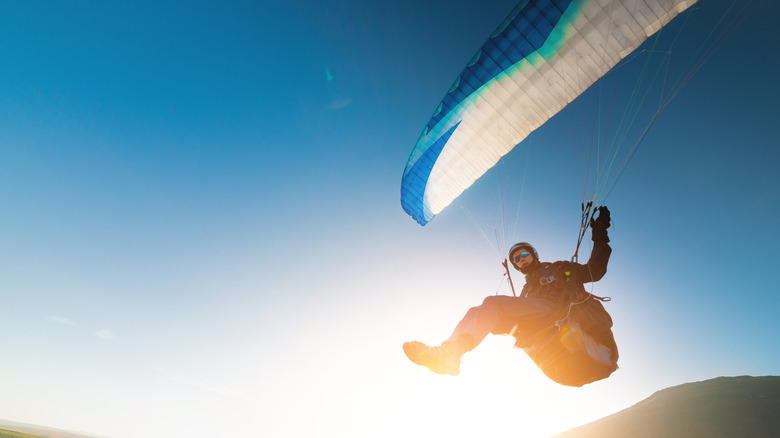 Silhouette of paraglider in air