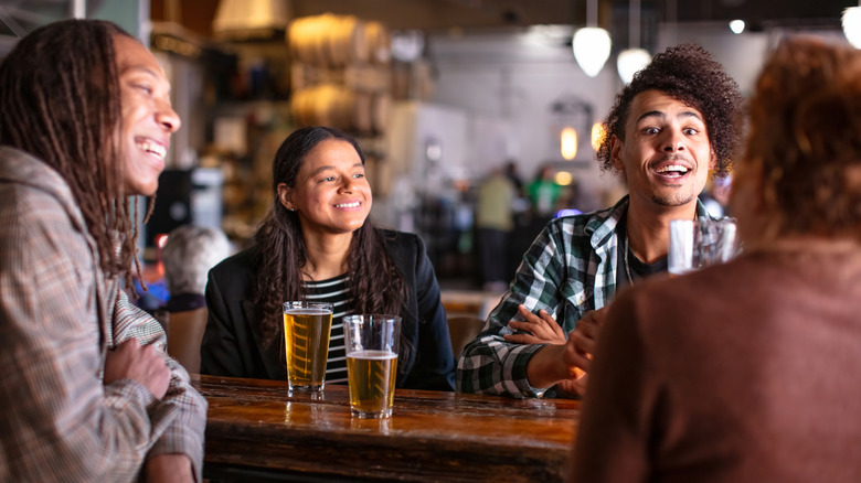 Group of friends chatting over beer in Denver brewery