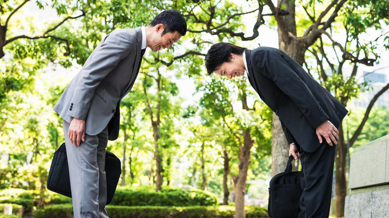 Two people bowing in Japan