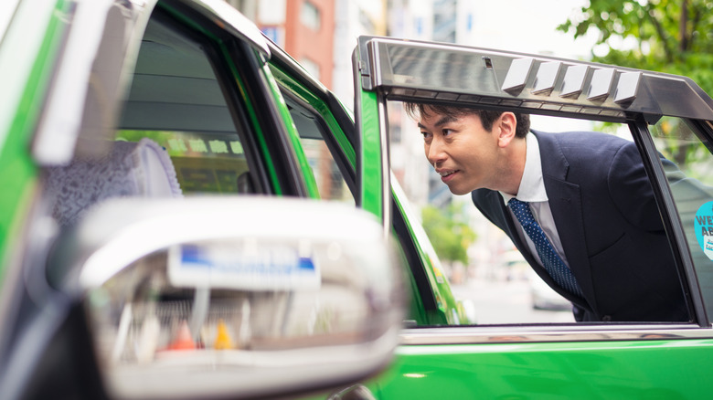 Person getting in a Tokyo taxi