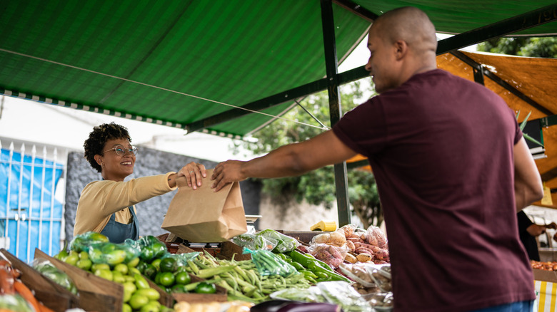 A tourist buying local fruit