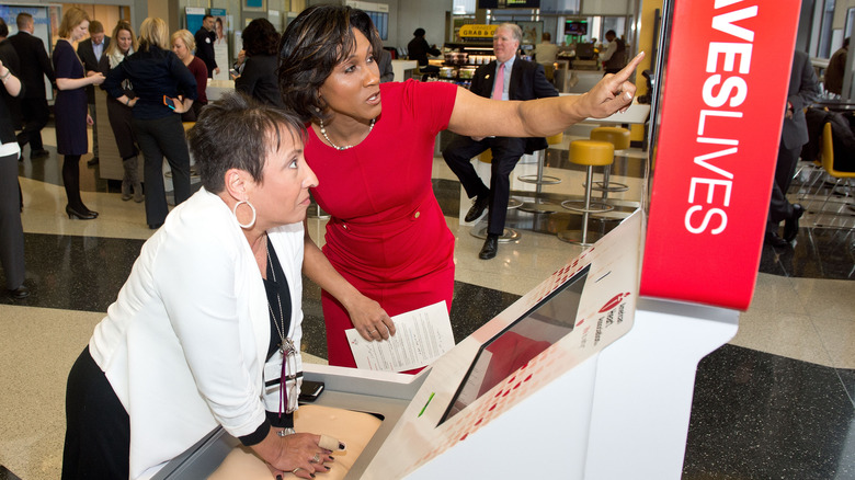 woman using cpr training kiosk