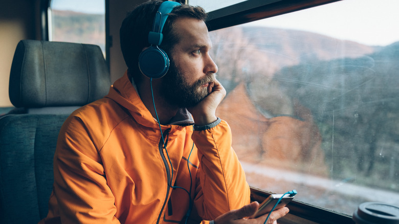 Man on train wearing headphones