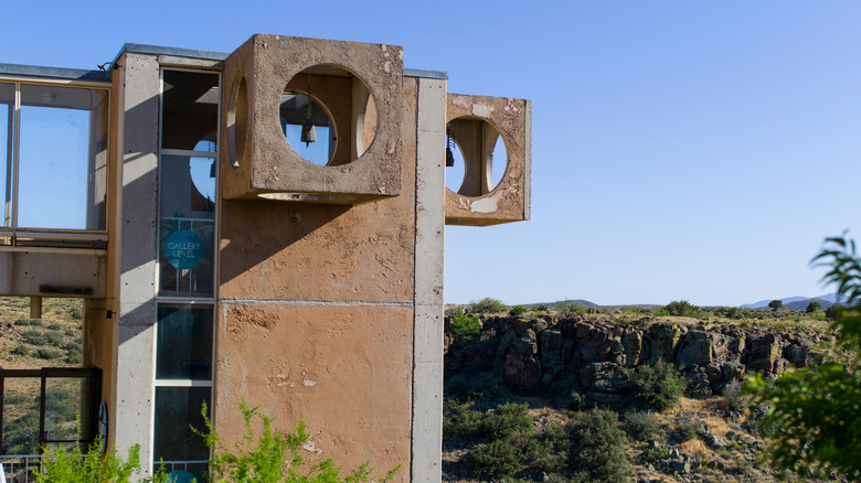 Concrete structure stands over desert.