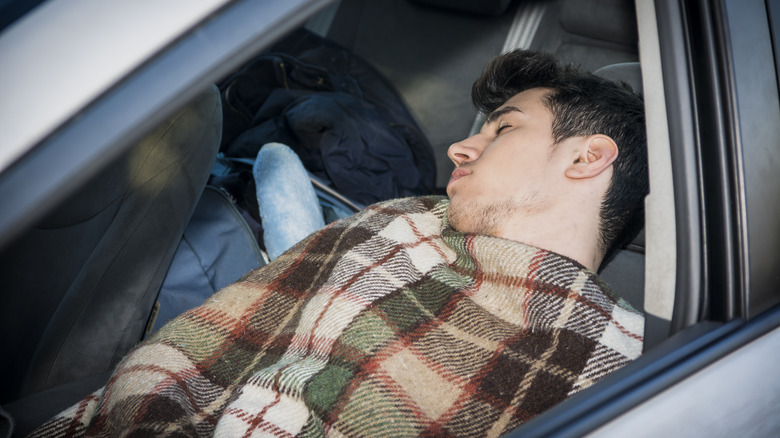 Man sleeping in car