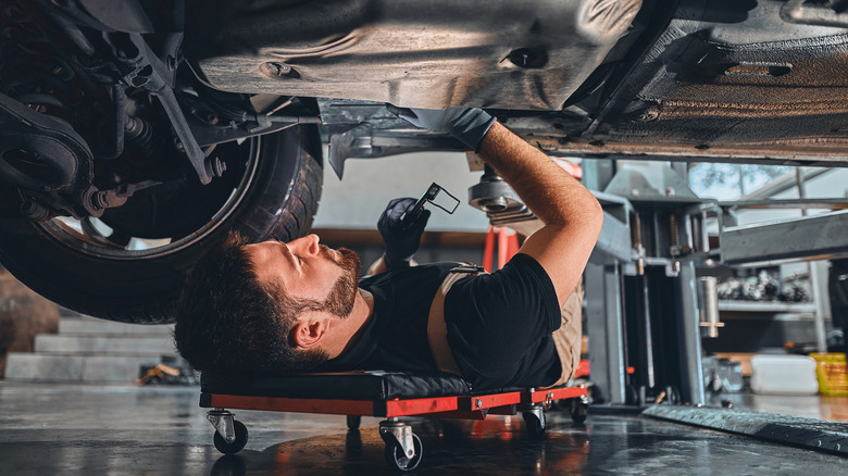 Mechanic under car