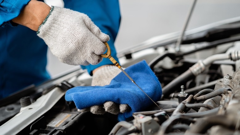 Mechanic checking car's oil