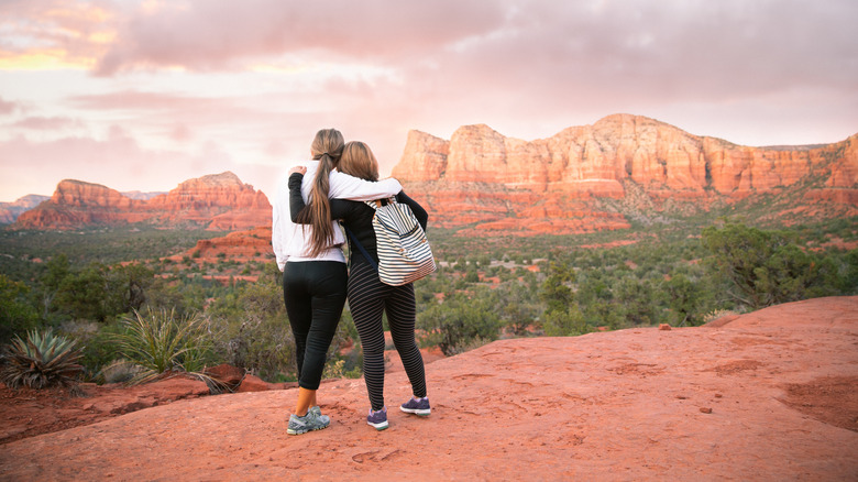 People hugging wearing hiking gear