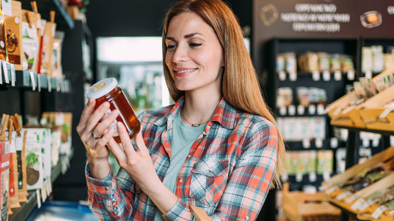  Woman holds honey jar 