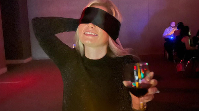 girl blindfolded at restaurant 