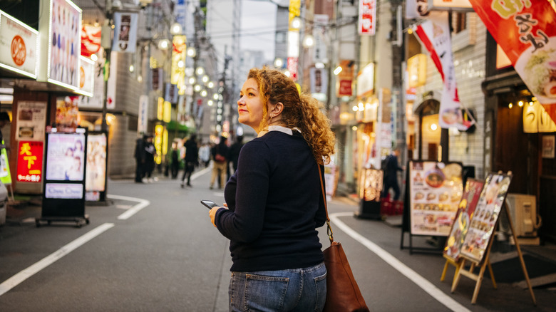 Woman using phone in Japan.