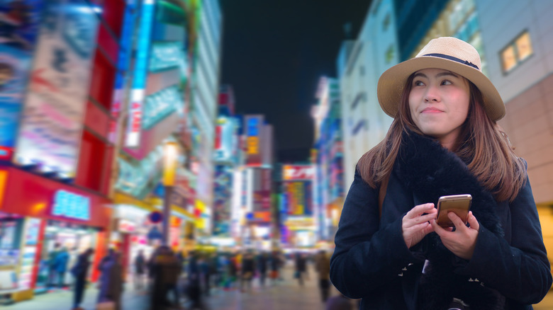Woman using phone in Japan.