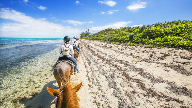 Horseback riders on the beach