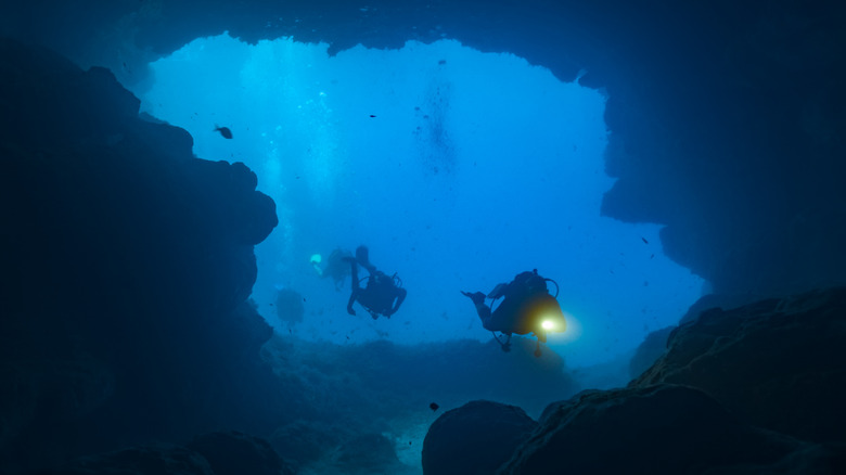 Cave divers exploring underwater cave