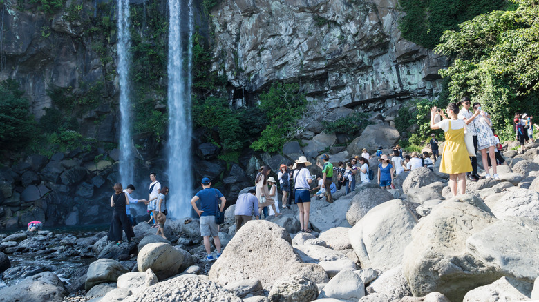 tourist crowds waterfall Jeju Island