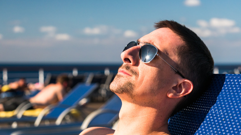 Man getting sun on a cruise