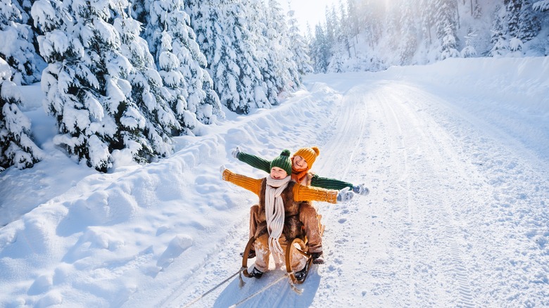 Children sledding in winter gear