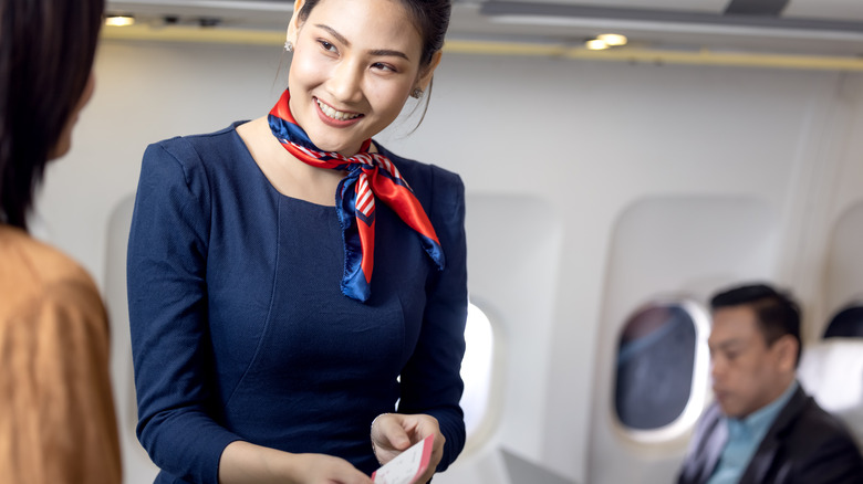 flight attendant smiling at passenger