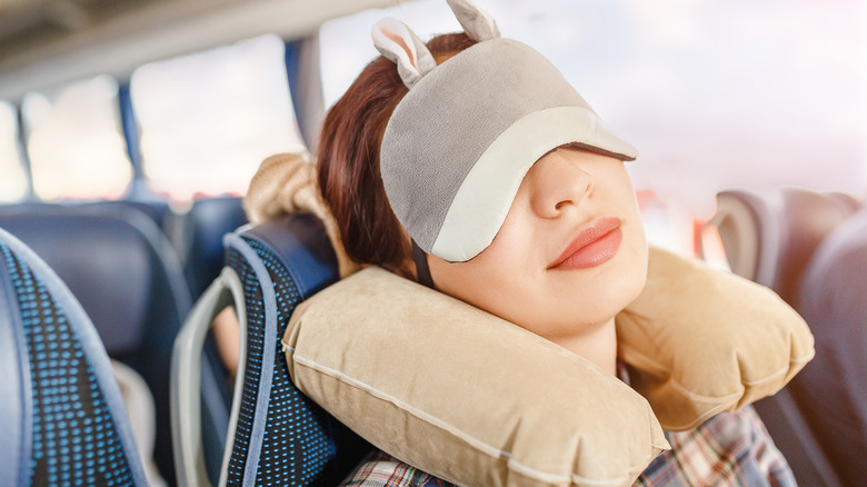woman on bus with travel pillow