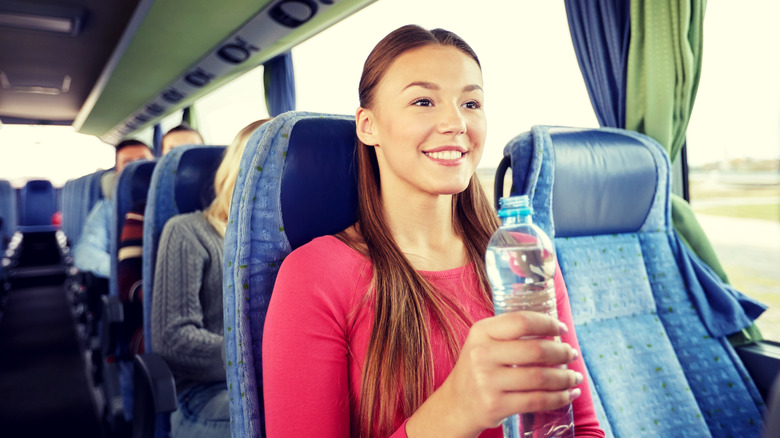 girl with water on bus