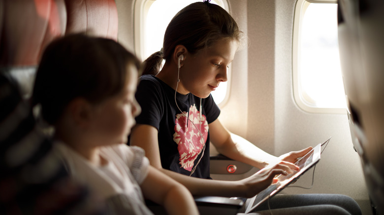 Girl watching movie on plane