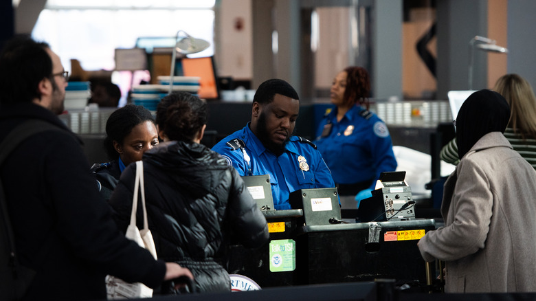 People speaking with TSA agents