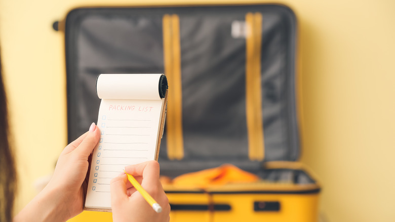 Woman writing a packing list